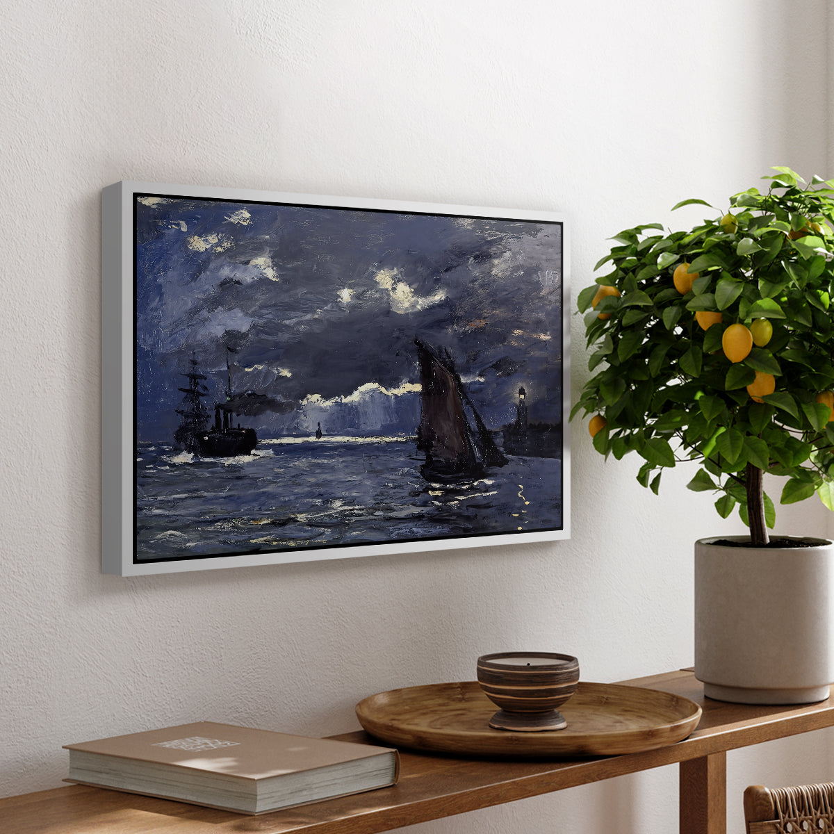 A Seascape, Shipping by Moonlight, 1864 by Claude Monet, presented in a white floater framed canvas featuring ships on dark sea illuminated by moonlight under night sky, displayed above a hallway console table.
