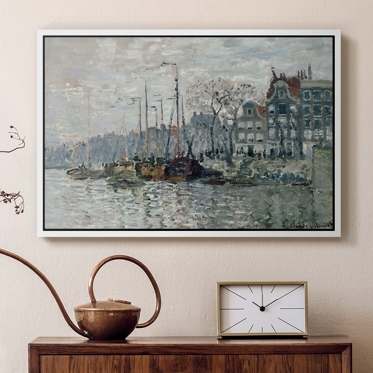 White floater framed canvas featuring an urban waterway with docked boats and European buildings, displayed above a cabinet in a soft-toned living room.