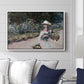 Young Girl in the Garden at Giverny, 1888 by Claude Monet displayed above a sofa in a living room in a white floater frame, featuring an impressionist garden scene with child among greenery and blossoms.