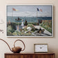 White floater framed canvas featuring a vibrant garden scene with colorful blooms and distant sea, displayed above a cabinet in a soft-toned living room.