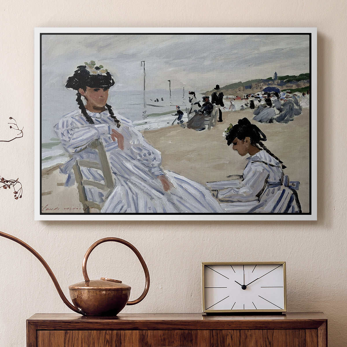 White floater framed canvas featuring a beach setting with people relaxing under umbrellas, displayed above a cabinet in a soft-toned living room.