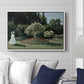 Woman in the Garden, Sainte-Adresse, 1867 by Claude Monet displayed above a sofa in a living room in a white floater frame, featuring an impressionist figure in sunlit garden with lush vegetation.
