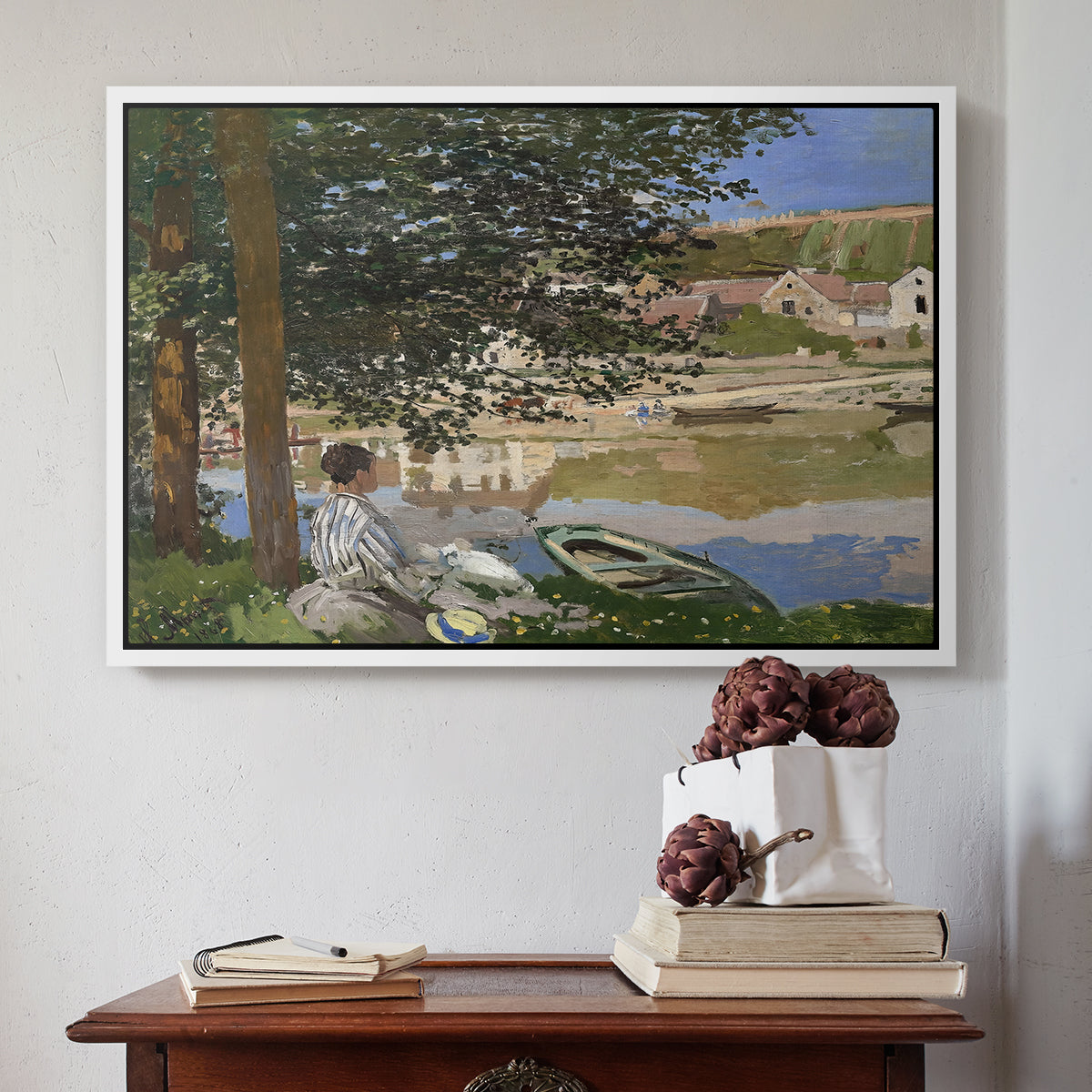 White floater framed canvas featuring On the Bank of the Seine, Bennecourt, 1868 by Claude Monet above an entryway table in a minimalist foyer.