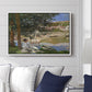 On the Bank of the Seine, Bennecourt, 1868 by Claude Monet displayed above a sofa in a living room in a white floater frame, featuring a peaceful riverside scene with figures resting in grassy area by water.