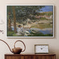 White floater framed canvas featuring an impressionist landscape with people relaxing along the Seine, displayed above a cabinet in a soft-toned living room.
