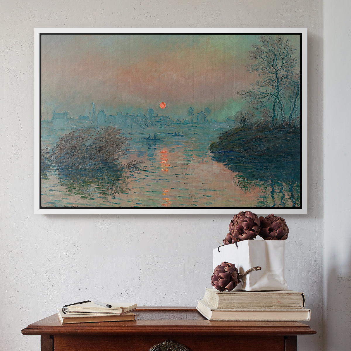 White floater framed canvas featuring Sunset on the Seine at Lavacourt, Winter Effect, 1880 by Claude Monet above an entryway table in a minimalist foyer.