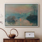 White floater framed canvas featuring an impressionist view of river at sunset with snowy banks, displayed above a cabinet in a soft-toned living room.