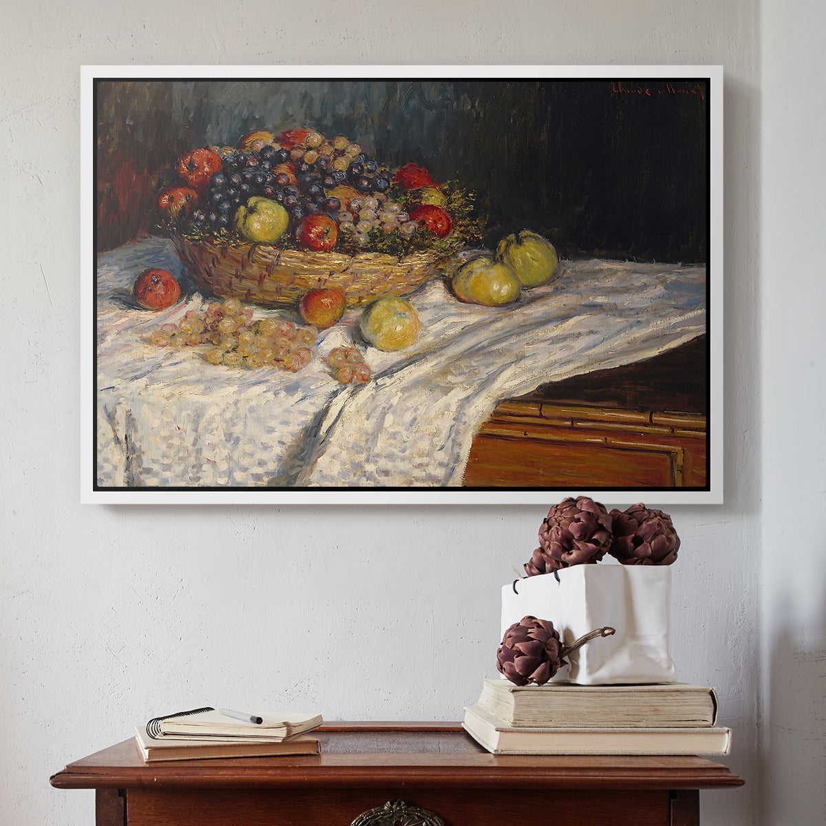 White floater framed canvas featuring Still Life with Apples and Grapes, 1880 by Claude Monet above an entryway table in a minimalist foyer.
