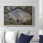 The Gare Saint-Lazare, 1877 by Claude Monet displayed above a sofa in a living room in a white floater frame, featuring an impressionist scene of trains and smoke inside busy railway station.