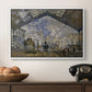 The Gare Saint-Lazare, 1877 by Claude Monet in a white floater framed canvas displayed above a console table in a hallway, featuring a bustling transport hub with trains beneath glass roof.
