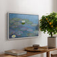 Water Lilies (Nymphéas), 1897-1899 by Claude Monet, presented in a white floater framed canvas featuring floating water lilies on pond with reflections of sky and foliage, displayed above a hallway console table.