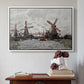 White floater framed canvas featuring Windmills near Zaandam, 1871 by Claude Monet above an entryway table in a minimalist foyer.