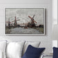Windmills near Zaandam, 1871 by Claude Monet displayed above a sofa in a living room in a white floater frame, featuring an impressionist view of Dutch windmills along riverbank.
