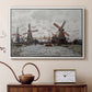 White floater framed canvas featuring a countryside scene with traditional windmills and reflections, displayed above a cabinet in a soft-toned living room.