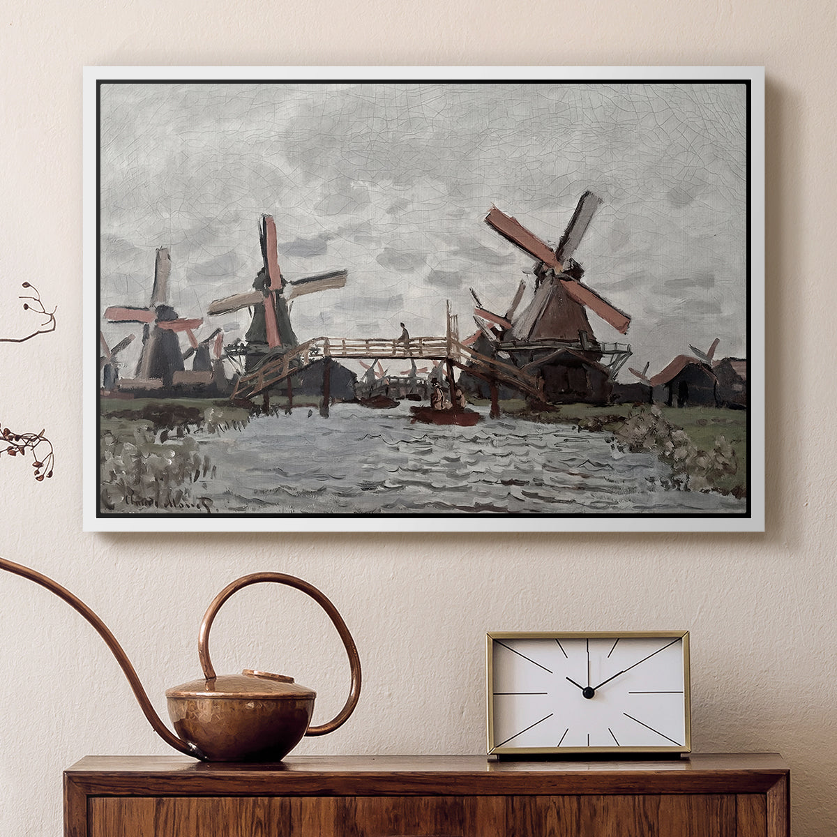 White floater framed canvas featuring a countryside scene with traditional windmills and reflections, displayed above a cabinet in a soft-toned living room.