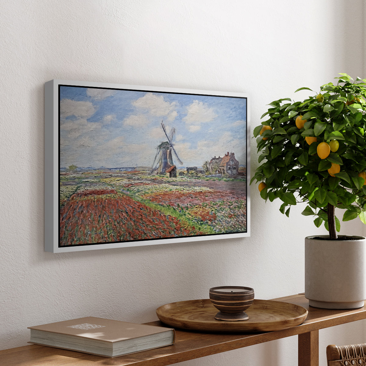 Tulip Fields with the Rijnsburg Windmill, 1886 by Claude Monet, presented in a white floater framed canvas featuring colorful rows of tulip fields leading toward distant windmill, displayed above a hallway console table.
