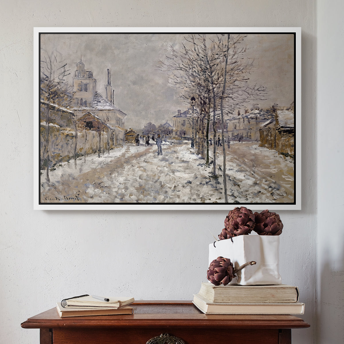White floater framed canvas featuring The Boulevard de Pontoise at Argenteuil, Snow Effect, 1875 by Claude Monet above an entryway table in a minimalist foyer.