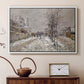 White floater framed canvas featuring a quiet boulevard blanketed in snow with distant figures, displayed above a cabinet in a soft-toned living room.