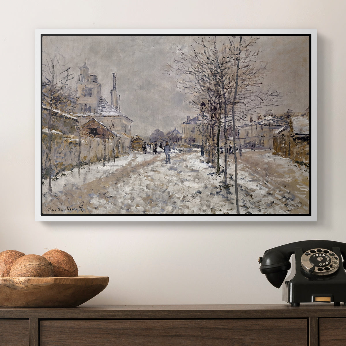 The Boulevard de Pontoise at Argenteuil, Snow Effect, 1875 by Claude Monet in a white floater framed canvas displayed above a console table in a hallway, featuring an urban winter landscape with muted tones and soft light.