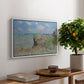 The Cliff Walk at Pourville, 1882 by Claude Monet, presented in a white floater framed canvas featuring figures walking along coastal cliff path overlooking ocean and sky, displayed above a hallway console table.