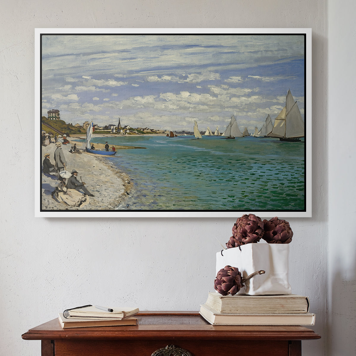 White floater framed canvas featuring Regatta at Sainte-Adresse, 1867 by Claude Monet above an entryway table in a minimalist foyer.
