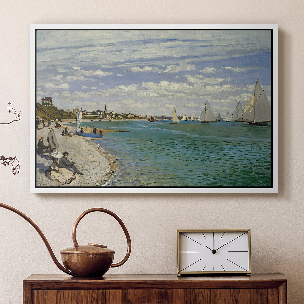 White floater framed canvas featuring an impressionist coastal view with colorful sails and shoreline activity, displayed above a cabinet in a soft-toned living room.