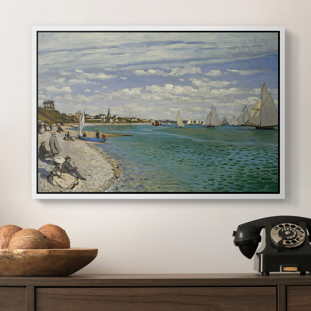 Regatta at Sainte-Adresse, 1867 by Claude Monet in a white floater framed canvas displayed above a console table in a hallway, featuring a nautical scene with boats racing near seaside town.