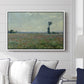 Poppy Field, 1881 by Claude Monet displayed above a sofa in a living room in a white floater frame, featuring an impressionist landscape filled with blooming flowers and greenery.