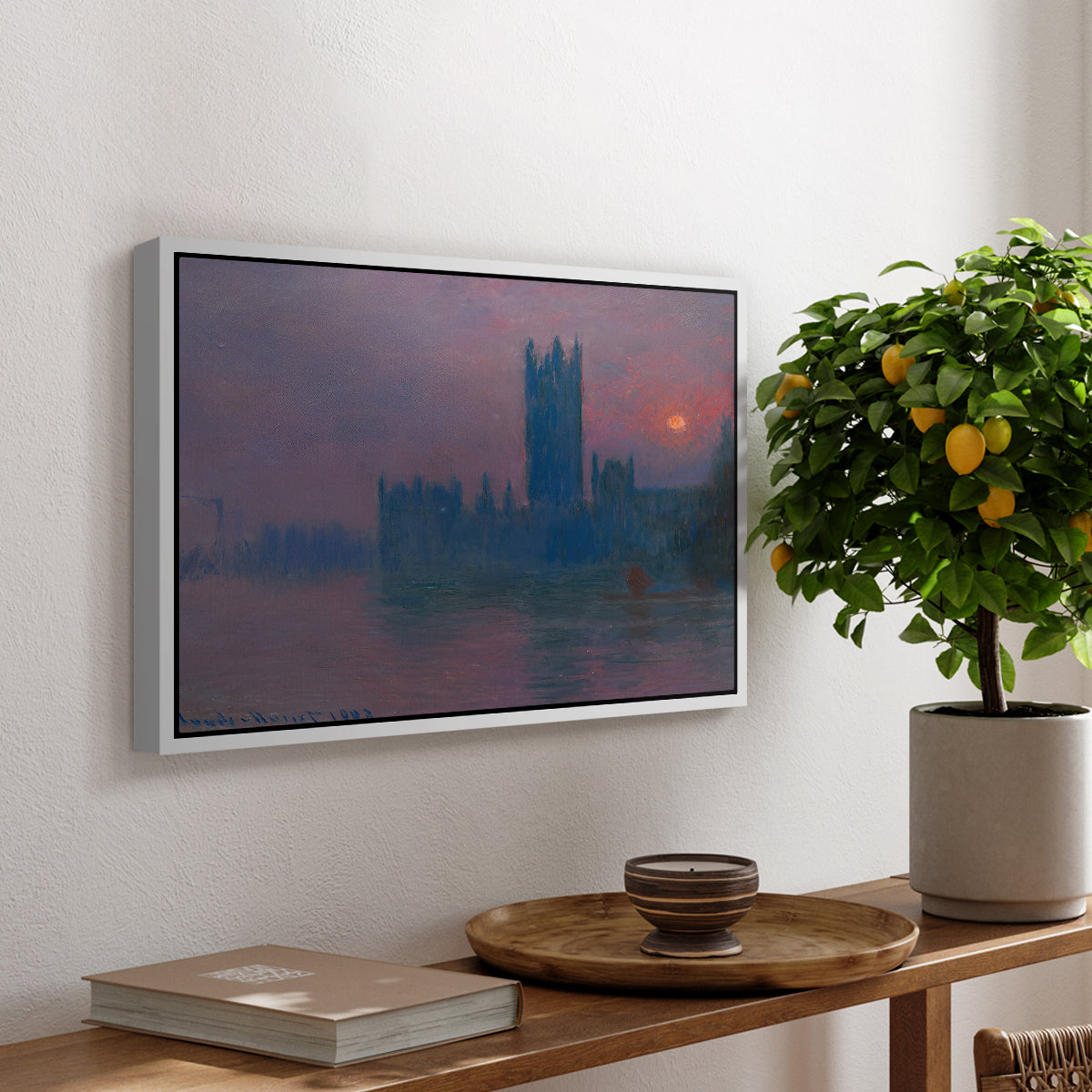 The Houses of Parliament, Sunset, 1903 by Claude Monet, presented in a white floater framed canvas featuring a silhouette of Parliament buildings against glowing sunset across river, displayed above a hallway console table.