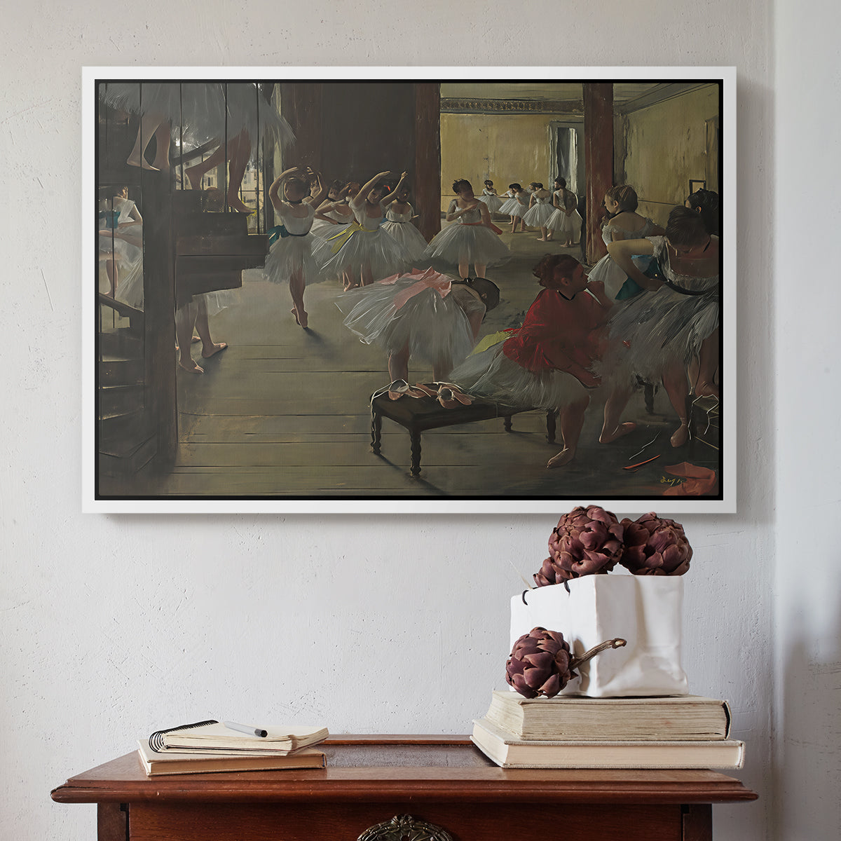 White floater framed canvas featuring The Dance Class, c. 1873 by Edgar Degas above an entryway table in a minimalist foyer.