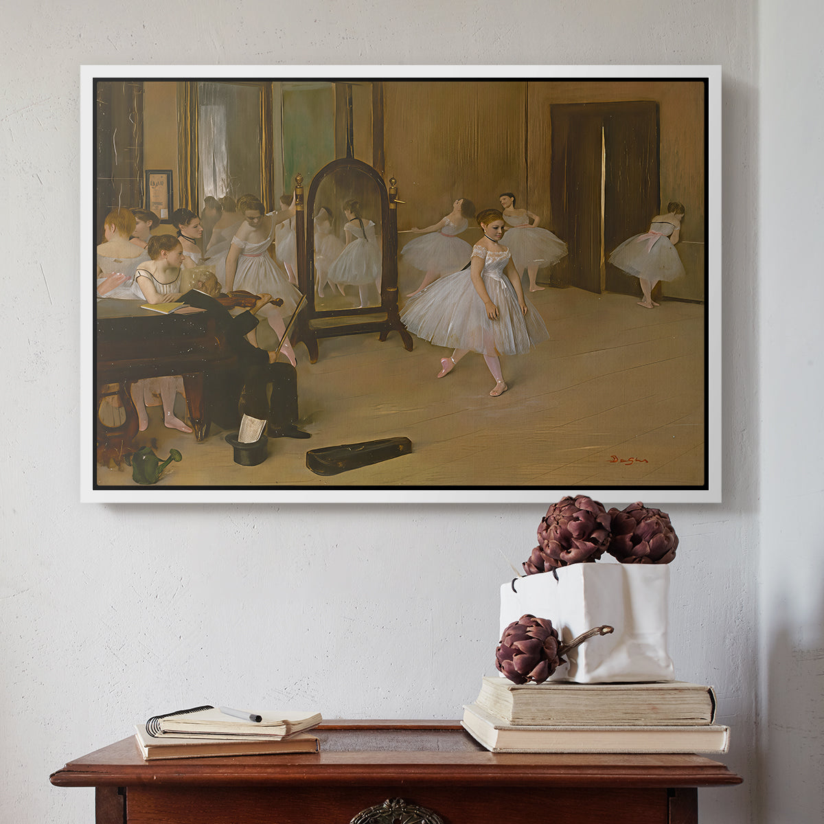 White floater framed canvas featuring The Dancing Class, c. 1870 by Edgar Degas above an entryway table in a minimalist foyer.