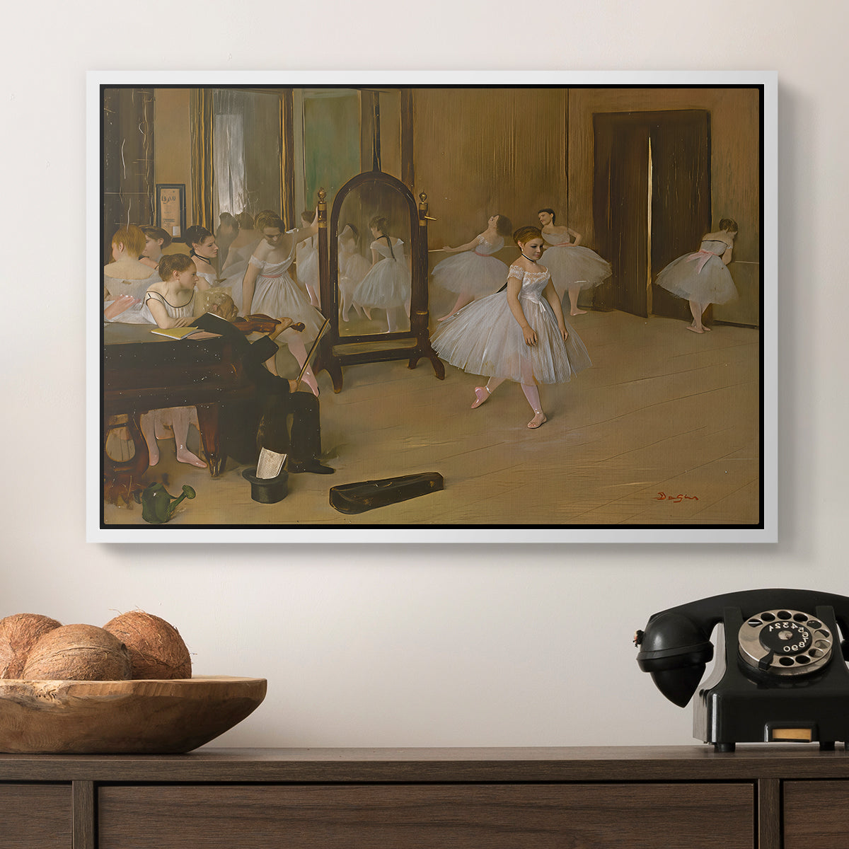 The Dancing Class, c. 1870 by Edgar Degas in a white floater framed canvas displayed above a console table in a hallway, featuring a group of dancers mid-practice with teacher overseeing.