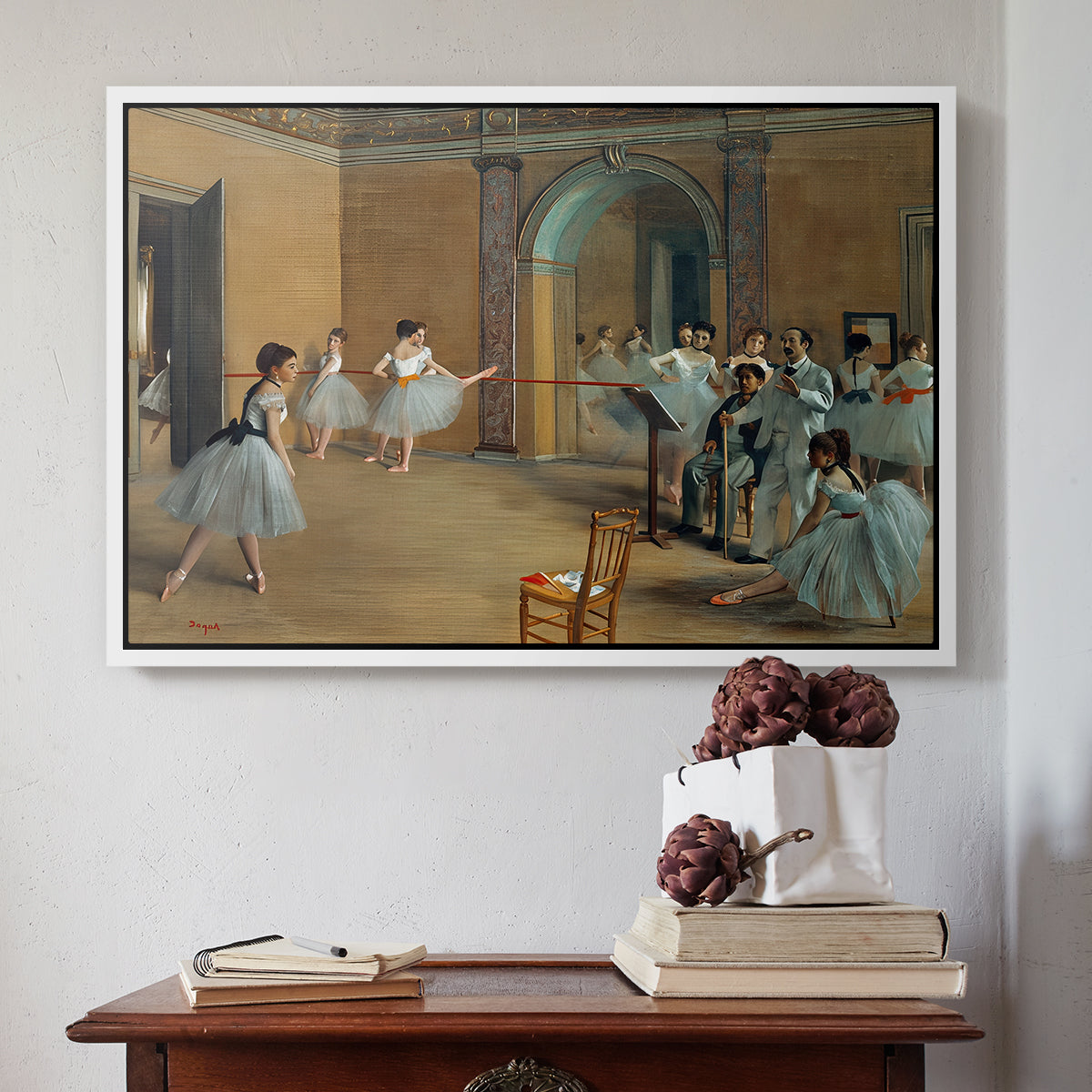 White floater framed canvas featuring The Dance Foyer at the Opera on the Rue Le Peletier, 1872 by Edgar Degas above an entryway table in a minimalist foyer.