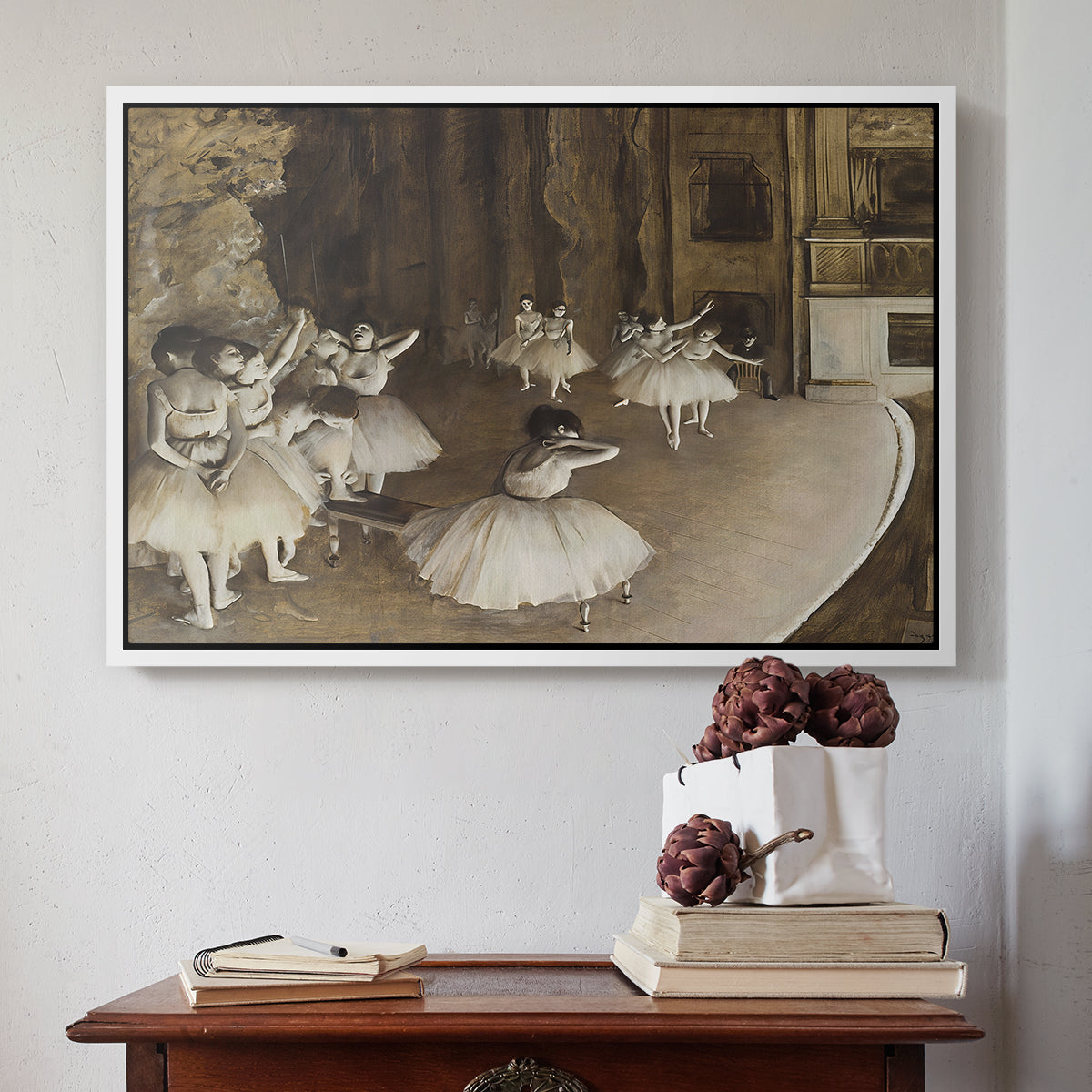White floater framed canvas featuring The Rehearsal of the Ballet Onstage, 1874 by Edgar Degas above an entryway table in a minimalist foyer.