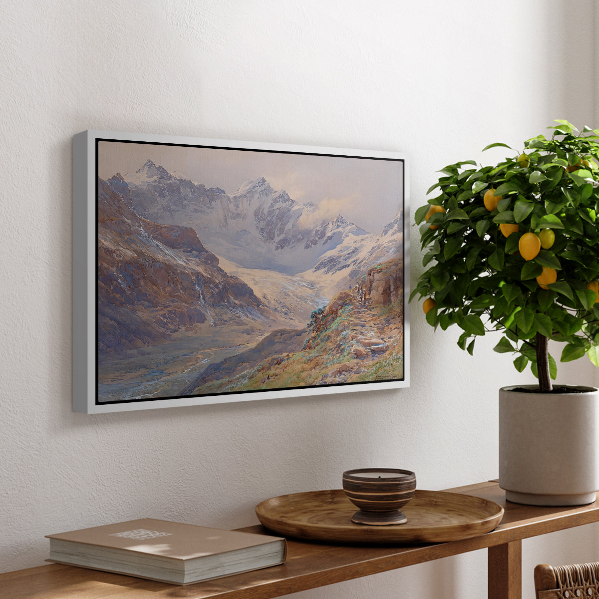 Odenwinklkees with the Johannisberg, 1902 by Edward Theodore Compton, presented in a white floater framed canvas featuring an alpine glacier landscape with rugged peaks and snow-covered terrain, displayed above a hallway console table.