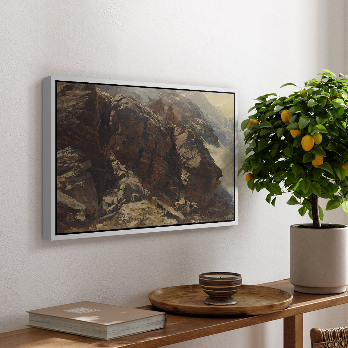 High Mountain Study, c. 1870 by Edward Theodore Compton, presented in a white floater framed canvas featuring a rocky alpine terrain with steep slopes and distant mountain peaks, displayed above a hallway console table.