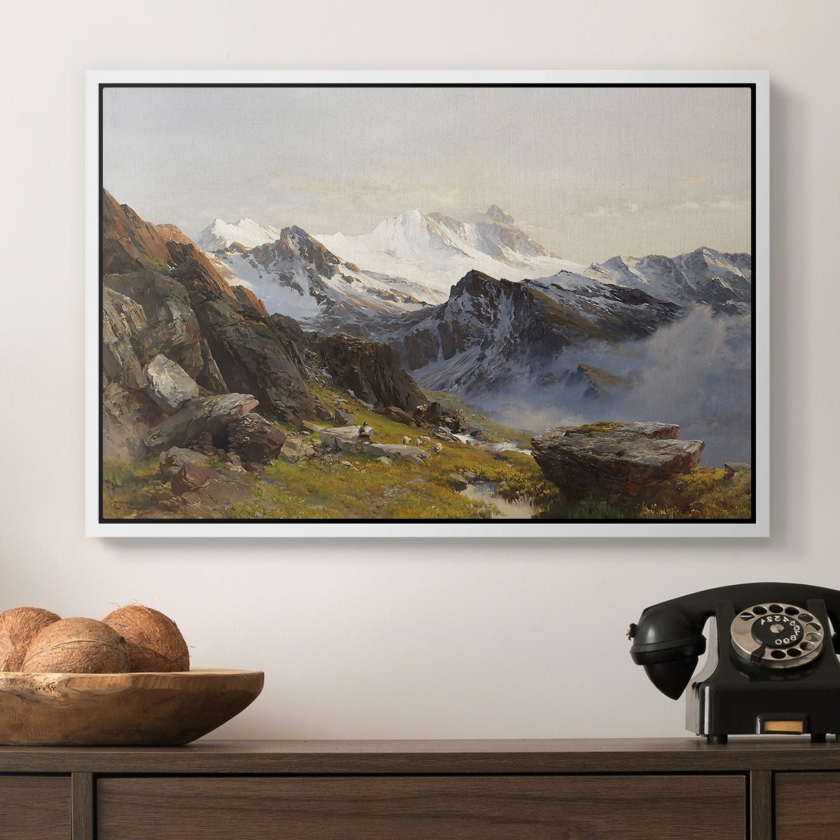 The Großglockner from the Prager Hut, 1890 by Edward Theodore Compton in a white floater framed canvas displayed above a console table in a hallway, featuring a scenic mountain view with dramatic elevation and depth.