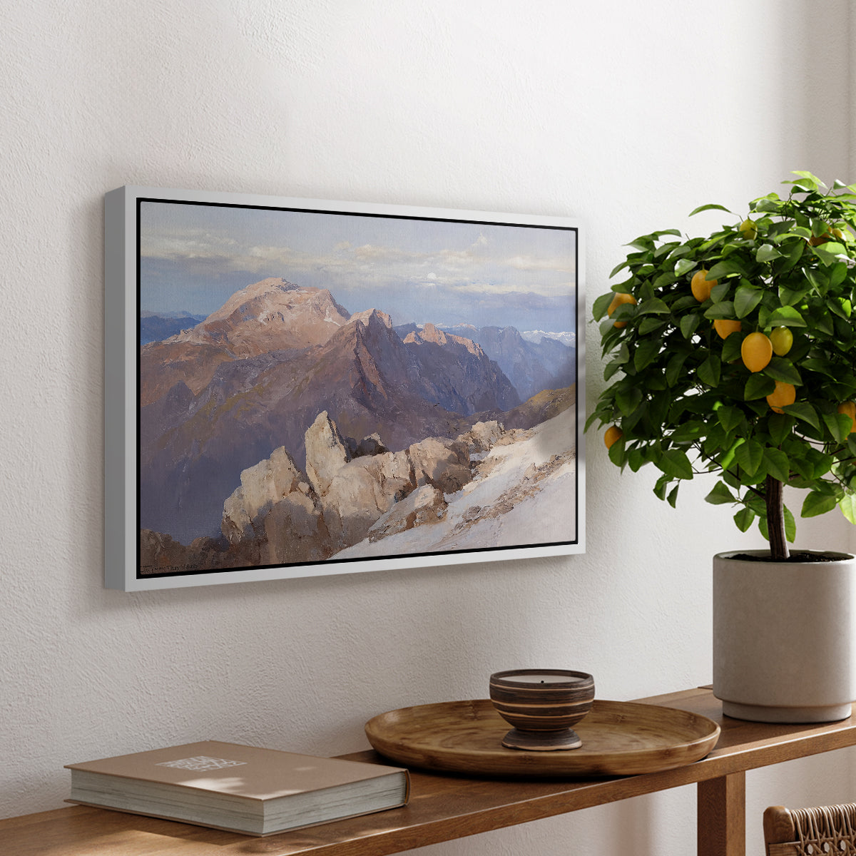 Hoher Göll from Watzmann-Hocheck, 1919 by Edward Theodore Compton, presented in a white floater framed canvas featuring a distant mountain peak viewed from elevated ridge with sweeping landscape, displayed above a hallway console table.