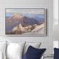 Hoher Göll from Watzmann-Hocheck, 1919 by Edward Theodore Compton displayed above a sofa in a living room in a white floater frame, featuring an alpine panorama showing layered peaks and valleys.