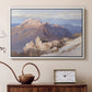 White floater framed canvas featuring a high vantage point overlooking rugged mountain terrain, displayed above a cabinet in a soft-toned living room.