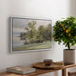 Landscape at Lake Starnberg, 1890 by Edward Theodore Compton, presented in a white floater framed canvas featuring a lakeside landscape with calm water and trees along shoreline, displayed above a hallway console table.