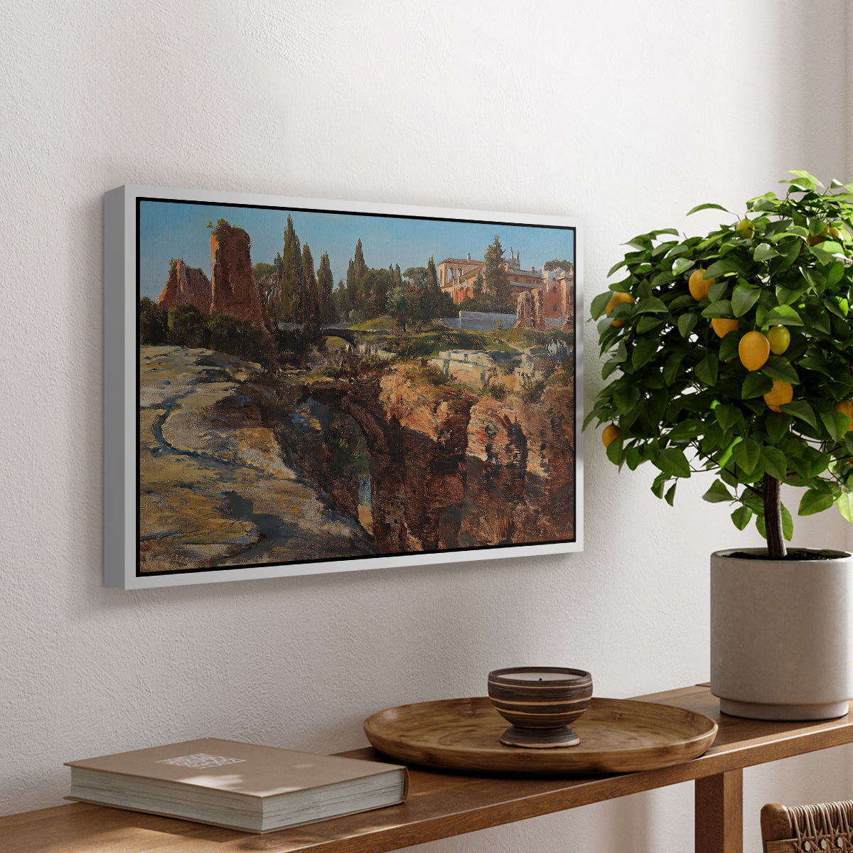 Palatine in Rome, c. 1921 by Edward Theodore Compton, presented in a white floater framed canvas featuring historic Roman ruins and buildings set within warm landscape, displayed above a hallway console table.