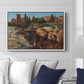 Palatine in Rome, c. 1921 by Edward Theodore Compton displayed above a sofa in a living room in a white floater frame, featuring an architectural scene of ancient structures in sunlit environment.
