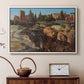 White floater framed canvas featuring a cityscape with classical ruins and surrounding terrain, displayed above a cabinet in a soft-toned living room.