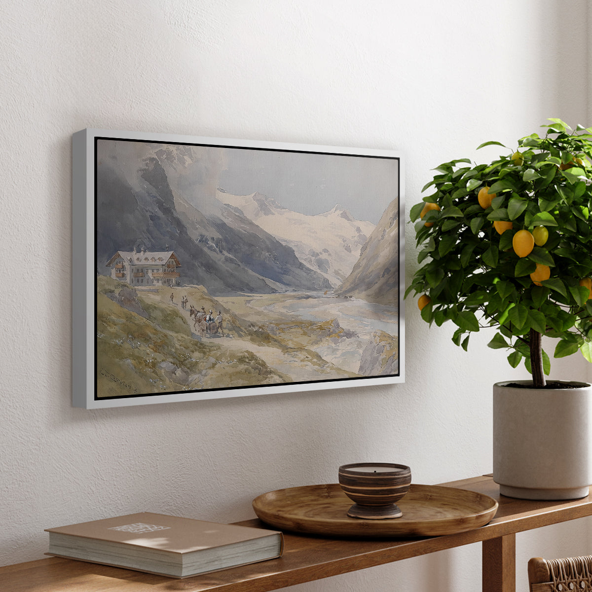 Shepherds (Pasterze), c. 1921 by Edward Theodore Compton, presented in a white floater framed canvas featuring a small group of shepherds in alpine landscape with grazing animals, displayed above a hallway console table.