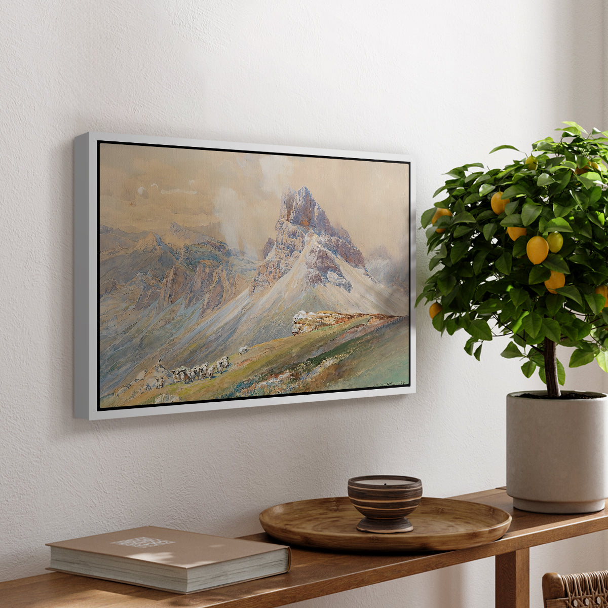 From the Dolomites, 1904 by Edward Theodore Compton, presented in a white floater framed canvas featuring dramatic Dolomite mountain peaks rising above rugged terrain, displayed above a hallway console table.