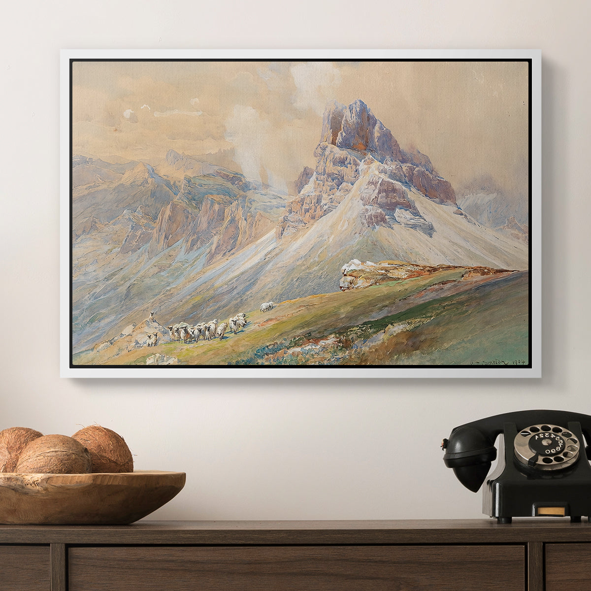 From the Dolomites, 1904 by Edward Theodore Compton in a white floater framed canvas displayed above a console table in a hallway, featuring a realistic mountain view with strong geological forms.