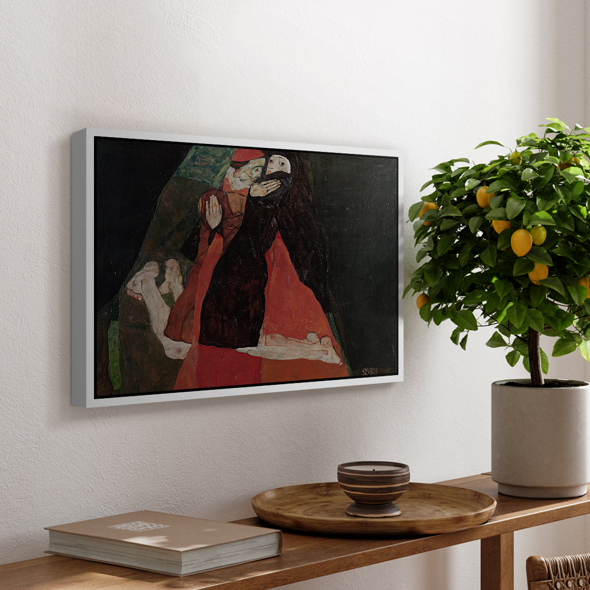 Cardinal and Nun (Caress), 1912 by Egon Schiele, presented in a white floater framed canvas featuring two figures embracing intimately in stylized expressionist composition, displayed above a hallway console table.