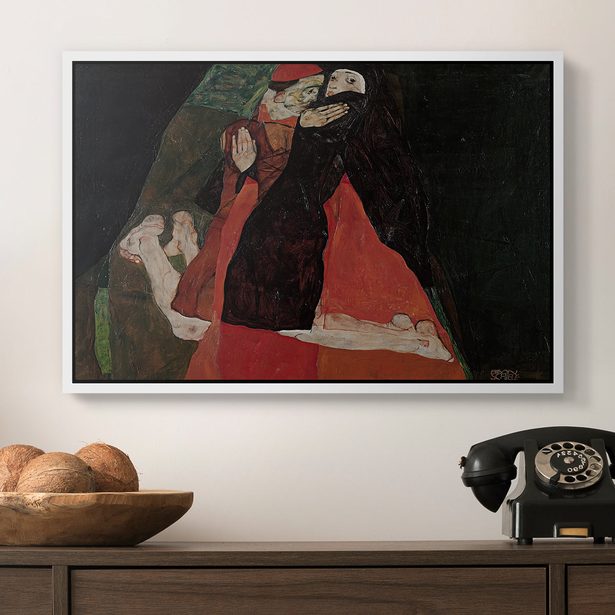 Cardinal and Nun (Caress), 1912 by Egon Schiele in a white floater framed canvas displayed above a console table in a hallway, featuring an intimate scene with religious figures in modernist style.