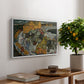 Crescent of Houses II (Island Town), 1915 by Egon Schiele, presented in a white floater framed canvas featuring a curved row of colorful houses forming crescent shape along water, displayed above a hallway console table.